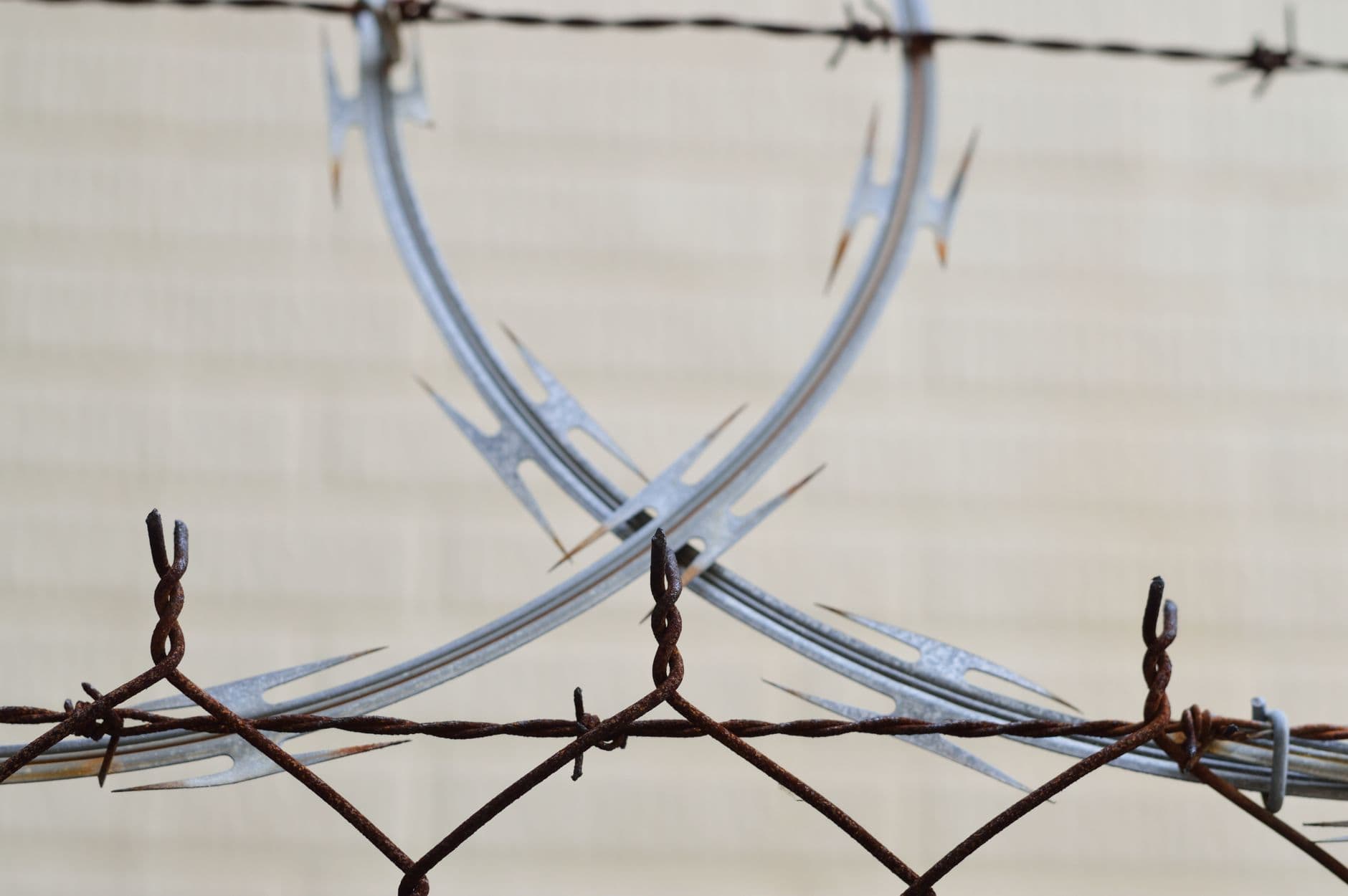 Detailed view of a rusted barbed wire fence for security and protection outdoors.